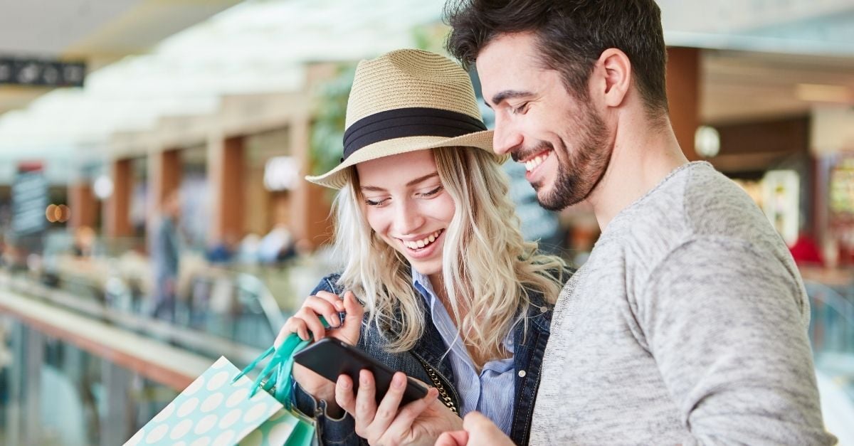 a couple using their phone to pay with points 